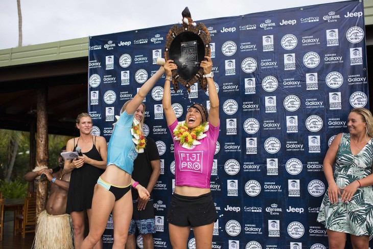Sally Fitzgibbons of Gerroa, NSW, Australia (pictured pink) celebrates her win at the Fiji Womens Pro after defeating South African Bianca Buitendag (pictured blue) in eight-to -ten foot Cloudbreak, in the Final, on Thursday June 4, 2015. Fitzgibbons surfed with her head bandaged after bursting her eardrum earlier in the week.